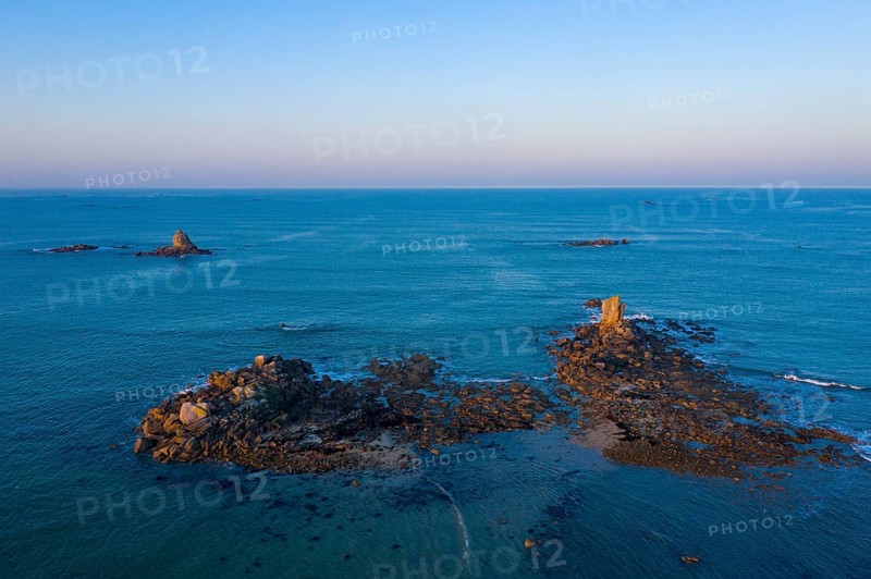 Aerial view of rock formations in the sea in front of the sandy beach Ker Emma shortly in front of sunset