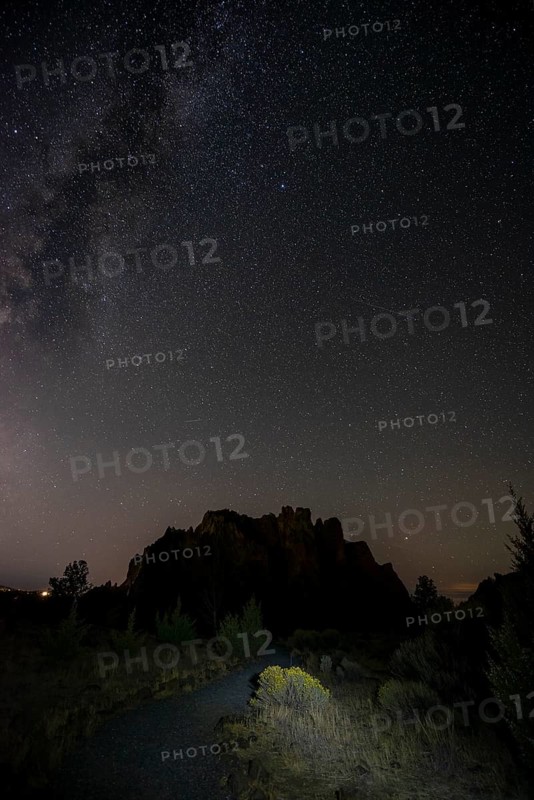 Lighted path and canyon against night sky