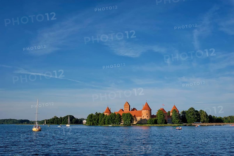 Trakai Island Castle in lake Galve with boats and yachts in summer day with beautiful sky