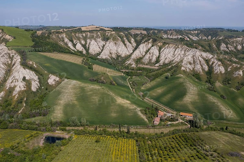 Aerial view of a hilly landscape with erosion valleys