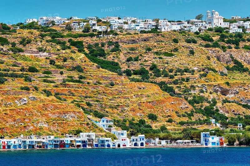 Klima and Plaka villages with whitewhashed traditional houses and orthodox church and windmills on Milos island