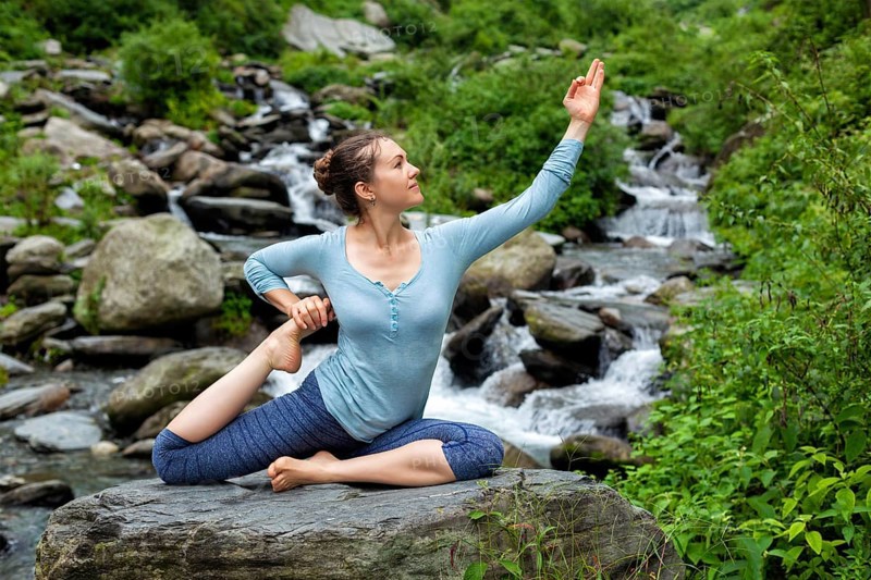 Young sporty fit woman doing yoga asana Eka pada rajakapotasana