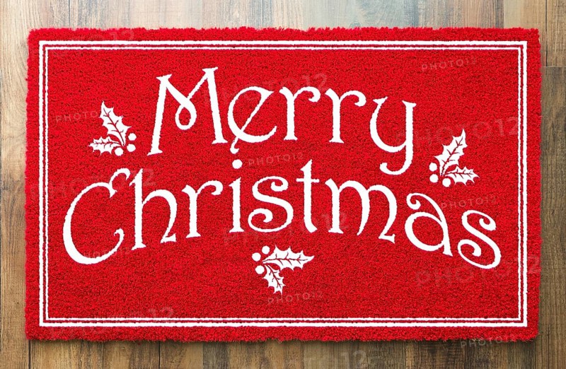Merry christmas red welcome mat on wood floor background