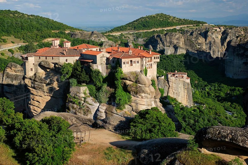 Monastery of Varlaam monastery and Monastery of Rousanou in famous greek tourist destination Meteora in Greece on sunset with scenic scenery landscape