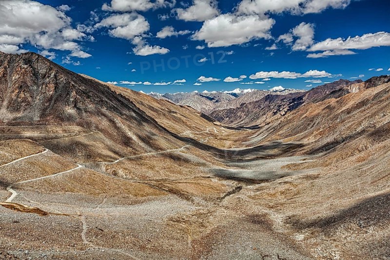 View of Karakoram range and road in valley from Kardung La