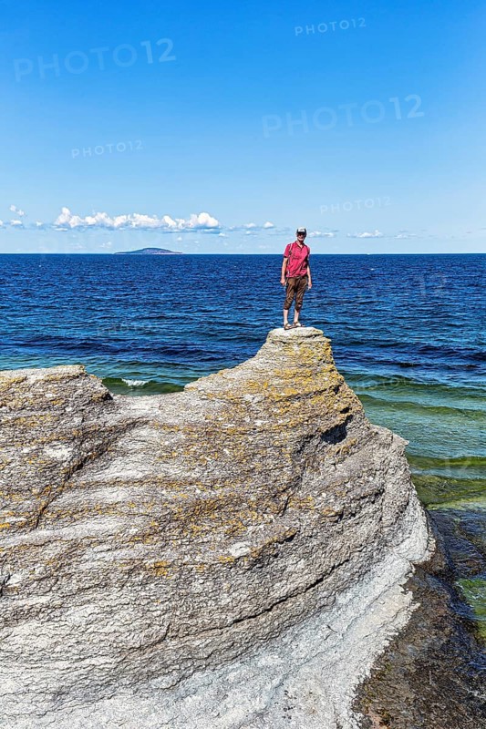 Hiker standing on limestone column