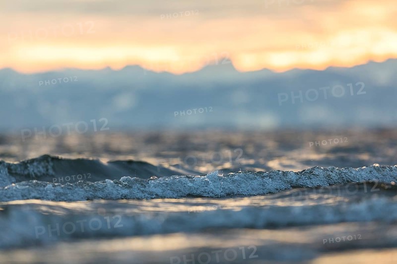 Sunrise on a wintry lake in bad weather