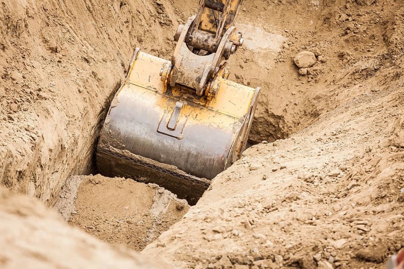 Working excavator tractor digging A trench