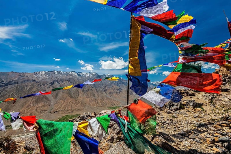 Buddhist prayer flags lungta with Om mani padme hum mantra written on them in Spiti Valley in Himalayas