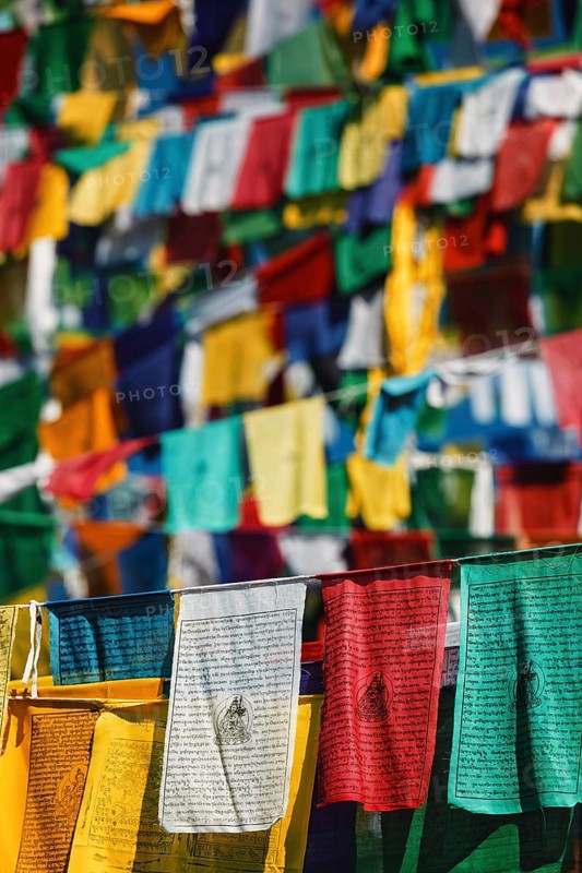 Buddhist prayer flags lungta with Om Mani Padme Hum Buddhist mantra prayer meaning Praise to the Jewel in the Lotus on kora around Tsuglagkhang complex
