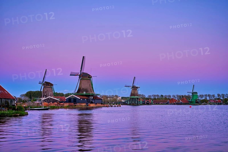Windmills at famous tourist site Zaanse Schans in Holland in twilight after sunset. Zaandam