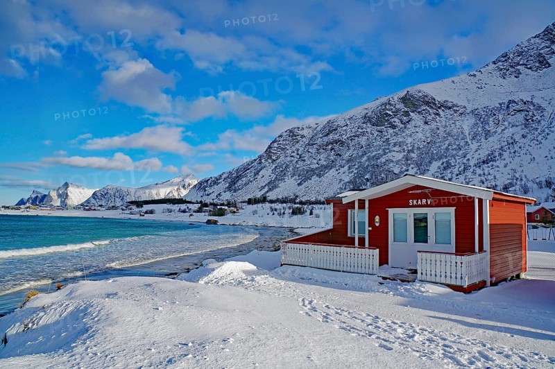 Red cottage in winter landscape