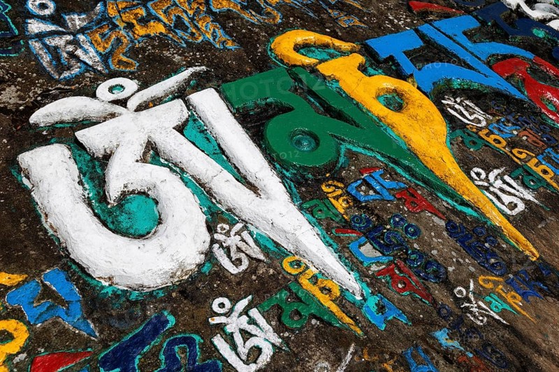Buddhist mantra Om mani padme hum written many times stone