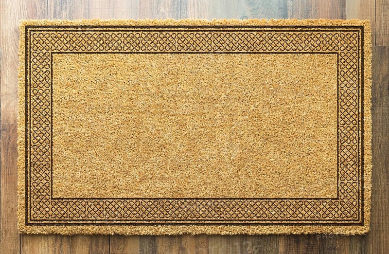 Blank welcome mat on wood floor background ready for your own text