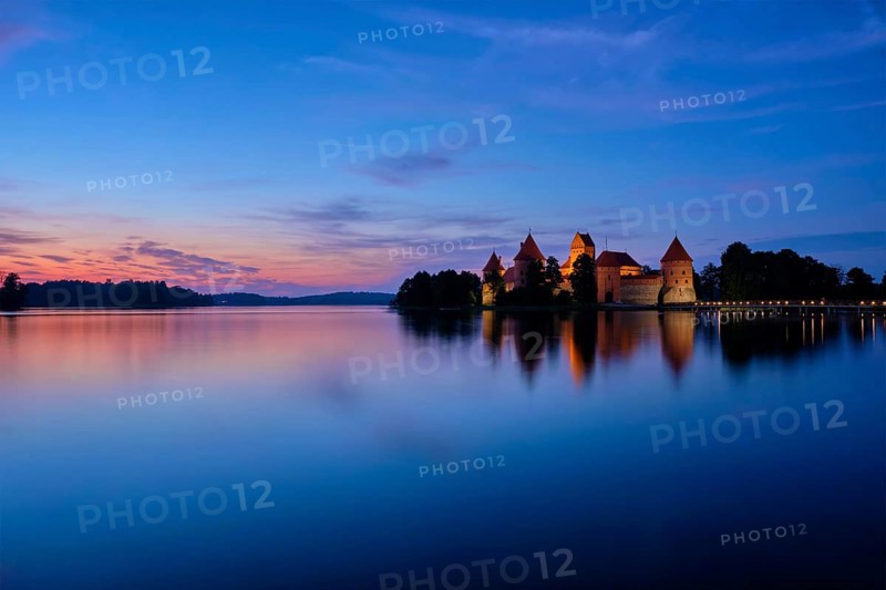 Night view of Trakai Island Castle in lake Galve illuminated in the evening