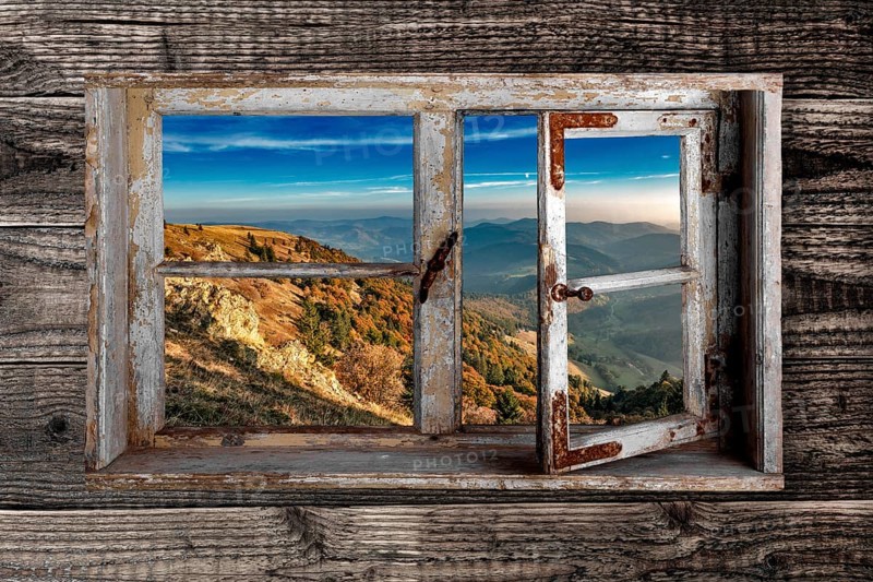 View through a rustic wooden window from the Belchen into the small Wiesental