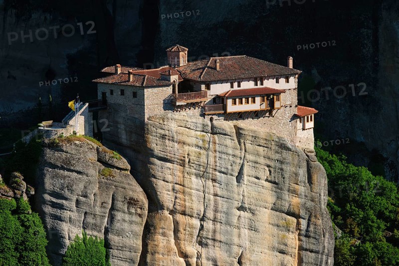 Monastery of Rousanou perched on a cliff in famous greek tourist destination Meteora in Greece on sunset with scenic landscape