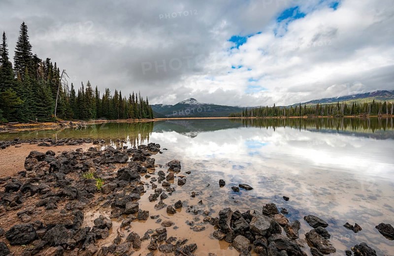 Black stones on the lake shore