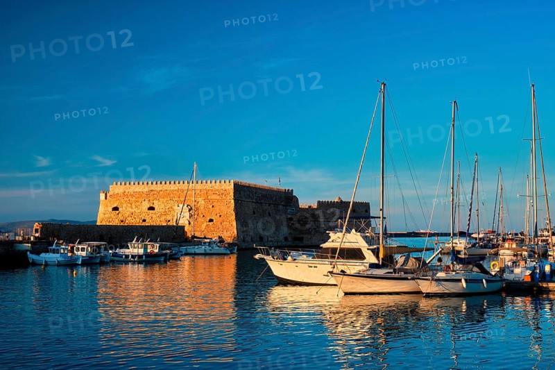 Venetian Fort Venetian fortress of Koules Castello a Mare castle in Heraklion and moored Greek fishing boats in port