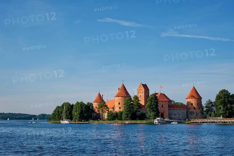 Trakai Island Castle in lake Galve with boats and yachts in summer