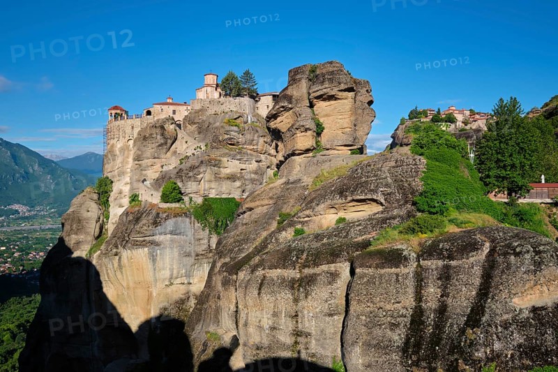 Monastery of Varlaam and Monastery of Great Meteoron in famous greek tourist destination Meteora in Greece on sunrise with scenic scenery landscape