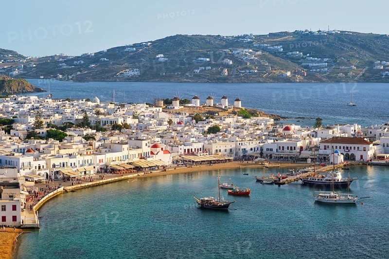 View of Mykonos town Greek tourist holiday vacation destination with famous windmills