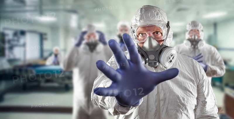 Team of female and male doctors or nurses wearing personal protective equipment in hospital emergency room