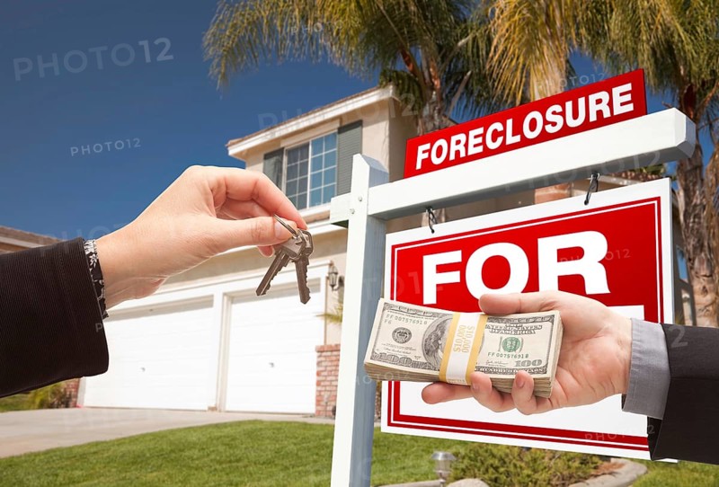 Handing over cash for house keys in front of house and foreclosure sign