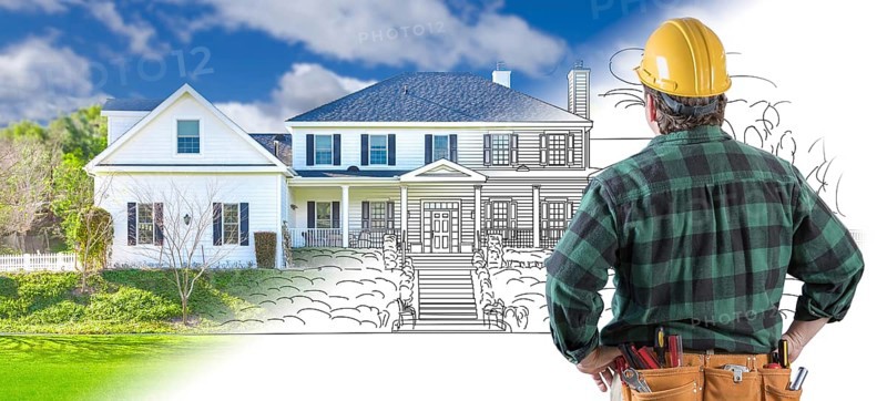 Male contractor with hard hat and tool belt looking at custom house drawing photo combination on white