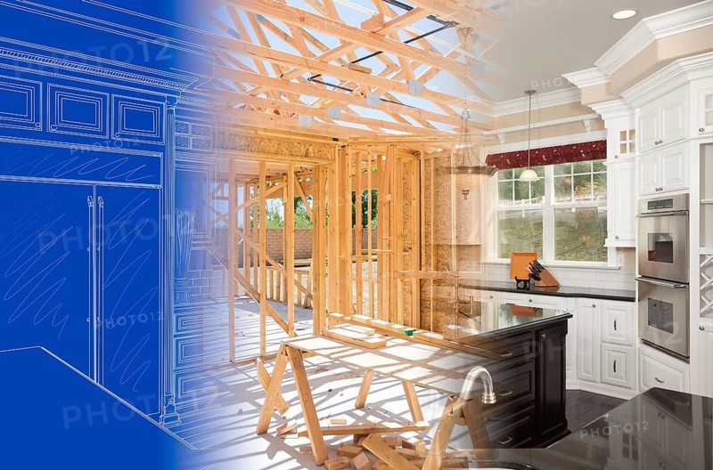 Kitchen blueprint drawing gradating into house construction framing then into finished build