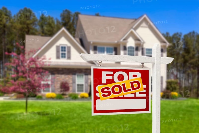 Sold home for sale real estate sign and beautiful new house