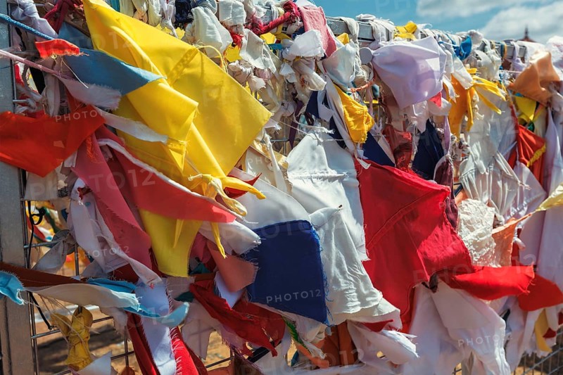 Multicolored fabric rags flags in Buddhist temple and pilgrimage site Ruwanweliseya Dagoba