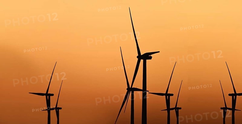Windmill at sunset against light