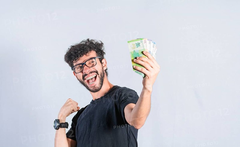 Excited man with money in hand