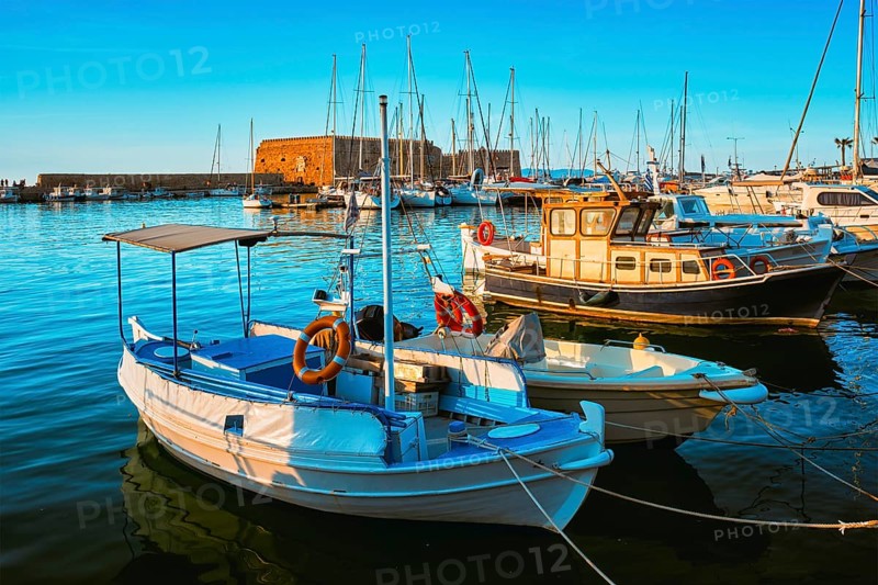 Venetian Fort Venetian fortress of Koules Castello in Heraklion and moored Greek fishing boats in port