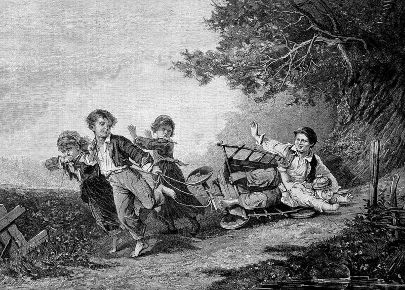 Children playing with an overturned handcart