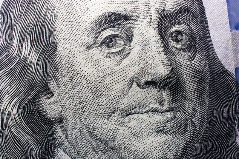 Close up of Benjamin Franklin face on 100 US dollar bill