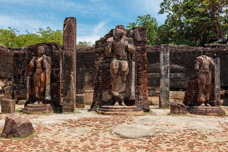 Standing Buddha statue in ancient ruins