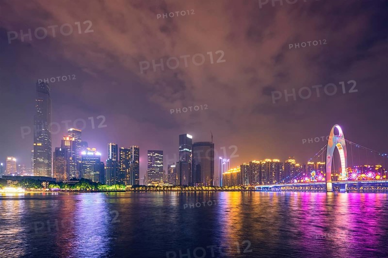 Guangzhou cityscape skyline over the Pearl River illuminated in the evening. Guangzhou