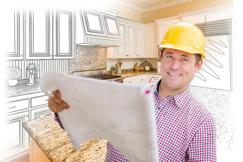 Smiling contractor holding blueprints over custom kitchen drawing and photo combination