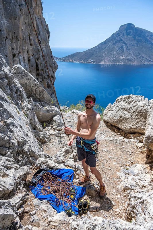 Climber belays on the ground