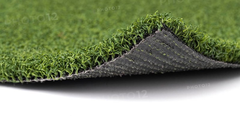 Flipped up section of artificial turf grass on white background