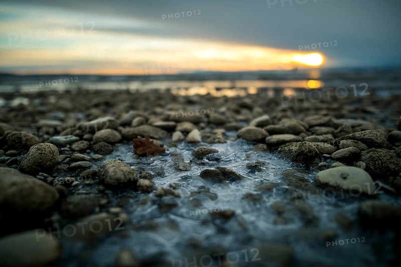 Sunrise on a wintry lake in bad weather