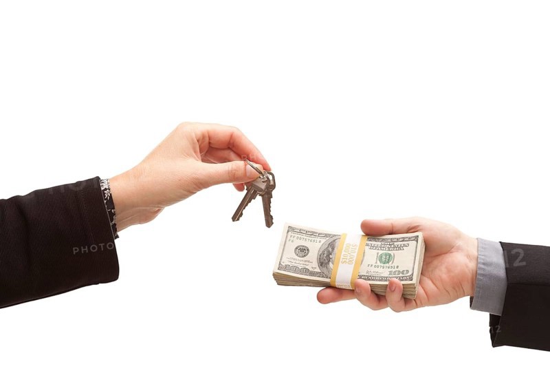Handing over cash for keys isolated on a white background