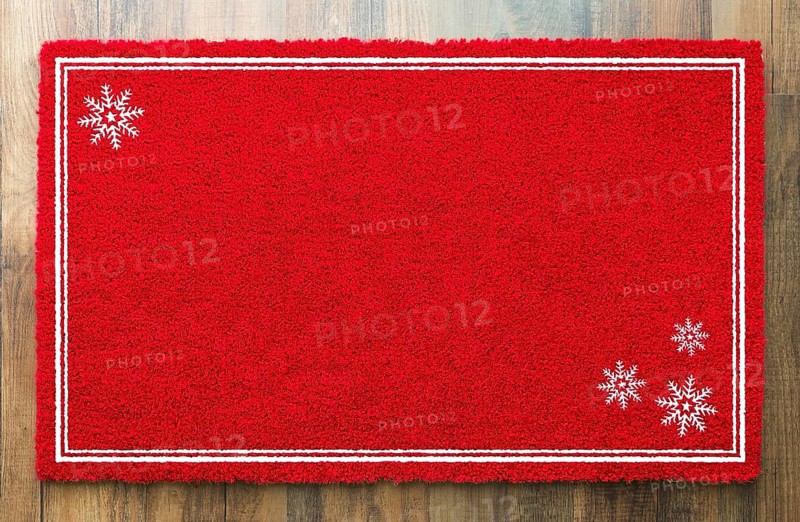 Blank holiday red welcome mat with snow flakes on wood floor background
