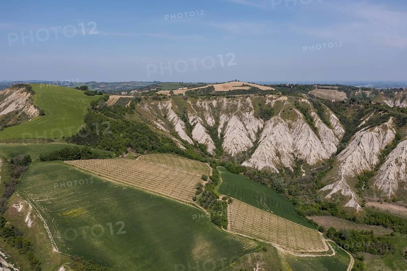 Aerial view of a hilly landscape with erosion valleys