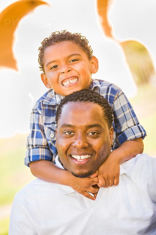 Happy african american father and mixed-race son playing at the park