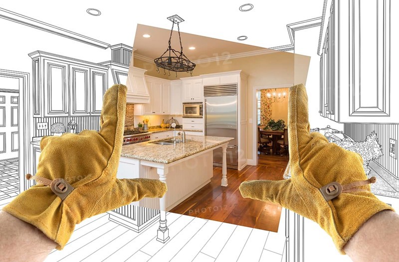 Male contractor hands framing completed section of custom kitchen design drawing