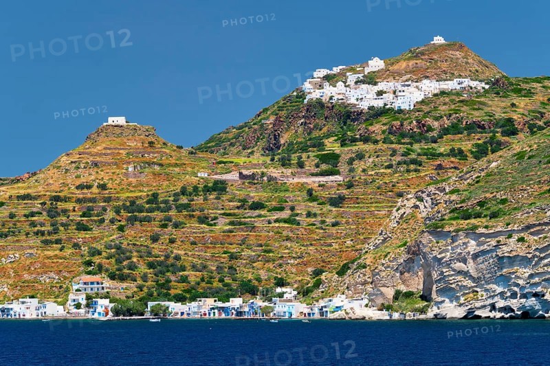 Klima and Plaka villages with whitewhashed traditional houses and orthodox church and windmills on Milos island