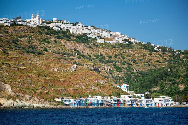 Klima and Plaka villages with whitewhashed traditional houses and orthodox church and windmills on Milos island